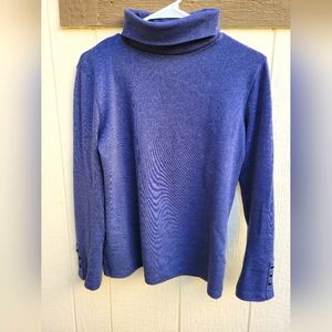 Blue turtleneck with black buttons on the sleeves